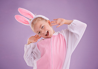 Image showing Portrait, rabbit and girl with costume, excited and Halloween outfit on purple studio background. Face, kid or model with bunny clothes and character with tradition or Easter with expression or funny