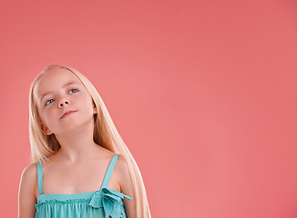 Image showing Girl, child and thinking on growth in studio, brainstorming and ideas on pink background. Female person, kid planning and confidence for childhood on mockup space, contemplating and innocent ponder