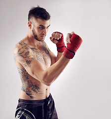 Image showing Fist, MMA and male fighter for martial arts pose, boxing and angry on white background. Wraps, hands and athlete for exercise and man kickboxer, studio and training for impact sports competition