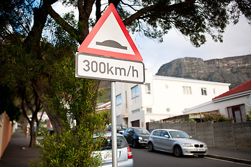 Image showing Road sign, warning and red triangle signage in street for speedbump with caution notification and speed limit. Attention, public notice and signpost for urban town, alert message and symbol by trees