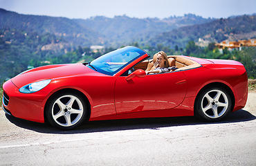 Image showing Woman, red sports car and road trip on weekend, travel and luxury transport on summer drive. Happy female person, holiday and countryside wellness on mountain, vacation and adventure in vehicle