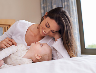 Image showing Mother, playful and care with baby girl on bed for bonding, love and relax together in bedroom. Parenting, happy woman and daughter for childhood development, support and nursery in apartment