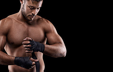 Image showing Boxing, man and hand wrap in studio with getting ready to fight, exercise or training on mockup space. Athlete, boxer and martial arts workout for competition, wellness or topless on black background