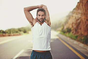 Image showing Road, runner and stretching of man, portrait and training for energy in nature of city of Cape Town. Adult, male person on highway, happy and sport with exercise to relax, wellness and healthy