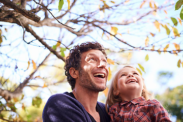 Image showing Father, daughter and excited in garden in autumn with trees, leaves and healthy childhood development. Family, man and girl child with happiness in backyard of home for bonding, recreation and relax