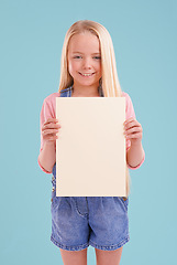 Image showing Child, portrait and poster mockup in studio for presentation for good news placard on blue background, announcement or board. Female person, face and smile or information banner, contact us or paper