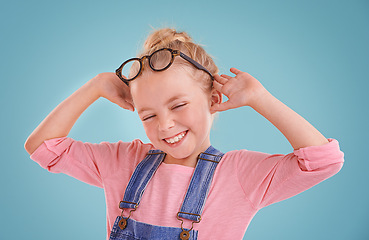 Image showing Child, happy and eye glasses in studio or healthy vision or optometry prescription, mockup space or blue background. Female person, kid and smile with spectacle frames for wellness, lens or optical