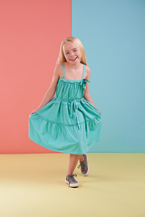 Image showing Girl, portrait and smile for curtsey in studio, child development and proud on color block background. Female person, mockup space and confident for childhood, positive attitude and satisfaction