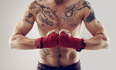 Image showing MMA, fist and wraps for male fighter in martial arts, boxing and angry on white background. Hands, athlete and exercise for man kickboxer, studio and training for impact sports competition or fitness