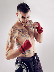 Image showing Fist, MMA and angry male fighter for martial arts pose, boxing and mad expression on white background. Wraps, hands and athlete for exercise and man kickboxer, studio and training for impact sports