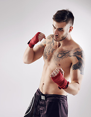 Image showing Fist, MMA and wraps for male fighter or boxer, pose and boxing on white background. Fitness, hands and athlete for exercise and man kickboxer, studio or training for impact sports or competition