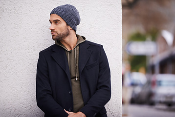 Image showing Fashion, man and thinking in wall outdoor with trendy, cool and style for urban with confident. Male person, choice and planning for weekend or holiday with winter outfit and stylish in Germany