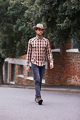 Image showing Man, road and outdoor cowboy fashion, western culture and countryside ranch in Texas. Male person, hat and flannel shirt for farmer aesthetic, nature and plaid style by trees or outside street