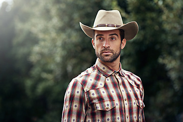 Image showing Man, style and outdoor cowboy fashion, western culture and countryside ranch in Texas. Male person, hat and flannel clothes for farmer aesthetic, nature and plaid trend by trees or outside bush