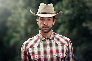 Image showing Man, portrait and outdoor cowboy clothes, western culture and countryside ranch in Texas. Male person, hat and flannel fashion for farmer aesthetic, nature and plaid style by trees or outside bush