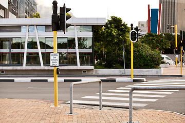 Image showing Road, traffic light and sign for pedestrian by crosswalk with mistake for humor, joke and comic grammar in city. Asphalt, error and funny signage with board, language and design with warning in town