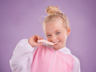 Image showing Studio, portrait and child with candy, marshmallow and tasty dessert for snack in isolated pastel purple background. Sweets, happy childhood and face of young girl for yummy food, hungry and eating