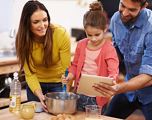 Image showing Family, kitchen and baking with tablet for recipe online with ingredients for cake or dessert with support and handmade. Mom, dad and girl child cooking together with love for bonding or teaching.