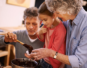 Image showing Help, grandparents and baking with girl, kitchen and home with happiness and bonding together with recipe. Family, grandchild and old man with senior woman and hobby with utensils, food and taste