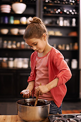 Image showing Girl, bake and learning with kid, food and ingredients with utensils and child development with dessert. Home, apartment and kitchen with recipe and prepare with pan and cupcake with joy and mixture