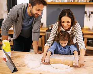 Image showing Family, cooking and learning in kitchen with tablet for recipe, guide and parents with child in home. Baking, mom and dad helping girl with rolling pin and talking about pizza, dinner or meal prep