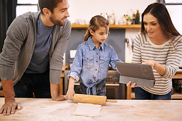 Image showing Family, learning and cooking in kitchen with tablet for recipe, guide and parents with child in home. Baking, mom and dad with girl helping to meal prep and reading about pizza, dinner or talking