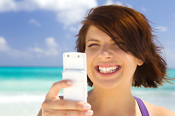Image showing happy woman with phone on the beach