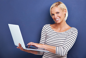 Image showing Woman, portrait and smile with laptop in studio for internet connectivity for online email, networking or blue background. Female person, face and technology for research blog, subscription or mockup