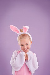 Image showing Portrait, rabbit and girl with costume, happiness and Halloween outfit on a purple studio background. Face, kid and model with bunny clothes and character with smile and Easter holiday with culture