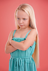 Image showing Frustrated, angry and girl with expression for sad, bad mood and unhappy in childhood isolated in studio background. Female child, gen z kid and arms crossed for tantrum, disappointment and serious