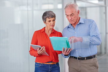 Image showing Documents, team or mature business people in discussion, planning or brainstorming strategy in office mockup. Ceo, man and serious woman in collaboration with tablet for project of financial advisors