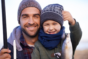 Image showing Portrait, child and smile with father, fish and happiness for achievement on break. Son, water and ocean with pride, adventure and vacation on fishing trip for childhood memories and success at sea