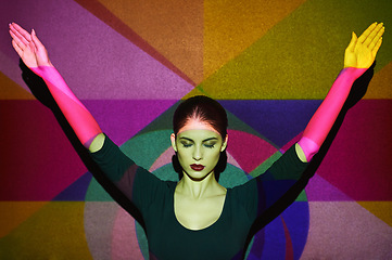 Image showing Arms, abstract and face of woman by color, art and pattern of shapes serious for creative career. Light, female person and surreal by wall with skin for cosmetics, beauty and makeup or treatment