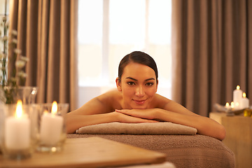 Image showing Candle, relax and portrait of woman on massage table at hotel for self care, stress relief and wellness. Female person, peace and zen face at spa for body health, hospitality and spiritual healing