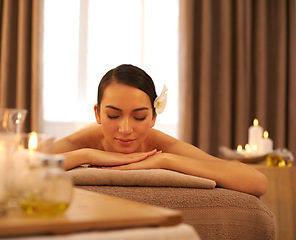 Image showing Woman, candle and relax with peace at spa for aromatherapy, stress and relief and holistic massage. Female person, smile and zen at luxury resort for body health, self care and spiritual healing