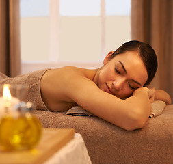 Image showing Peace, sleep and woman on massage table at spa for self care, stress relief and natural wellness. Female person, zen and calm at luxury hotel for body health, hospitality and spiritual healing