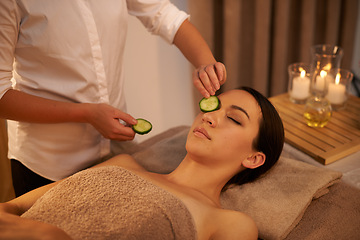 Image showing Face, massage therapist and woman with cucumber in spa for peace, relax or wellness. Facial, salon or hands apply vegetable on eyes for natural beauty, skincare or healthy organic treatment with mask