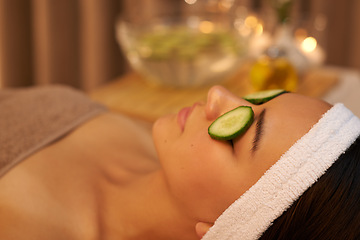 Image showing Spa, relax and woman with cucumber on face for skincare massage, peace or wellness. Facial, salon and person with vegetable on eyes in therapy for natural beauty or healthy organic treatment closeup