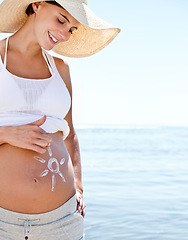 Image showing Pregnant woman, mom and sun drawing on belly with sunscreen, protection and summer at beach. Sea, travel and happy mother, health and wellness with skincare, vacation and sunblock for moisturizer