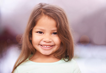 Image showing Girl, kid and smile for portrait in house, cute and sweet in lounge with happiness in family home. Female young person, adorable and innocent in living room for child development, youth and childhood