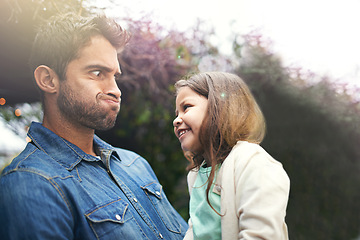 Image showing Father, funny and face with girl outdoors for silly or goofy moment together, laughter and happiness for dad or daughter bonding. Parent, kid and backyard for game with comic expression and comedy.