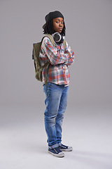 Image showing Attitude, crossed arms and portrait of child on gray background with headphones for song, audio and radio. Student, school and young African boy with bag in trendy style, clothes and outfit in studio