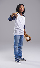 Image showing Baseball, portrait and child in a studio with ball, sport and fitness gear with a smile of a kid. Youth, happy and African boy with modern, casual and hipster fashion with a workout glove and a teen