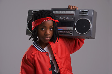 Image showing Child, hip hop and portrait with radio for cool music and dance in a studio with urban clothing. Fashion, African kid and boombox with trendy clothes and rap swag with confidence and grey background