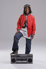 Image showing Teen, hip hop and portrait with radio for music and dance in a studio with urban clothing. Fashion, African person and boombox with trendy clothes and youth swag with confidence and grey background