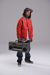 Image showing Child, hip hop and portrait with radio for music and dance in a studio with urban clothing. Fashion, African kid and boombox with trendy clothes and youth swag with confidence and grey background