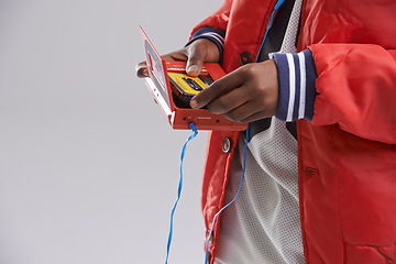 Image showing Hands, music and mix tape with player for cassette, hip hop and aesthetic for youth with culture. Retro, vintage and audio from track of mini boombox for kid or child in studio with grey background