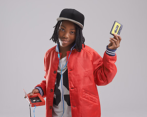 Image showing Music, portrait and child on gray background with cassette for listening to song, audio and radio. Fashion, youth and young African boy with retro tech for track playlist in trendy clothes in studio