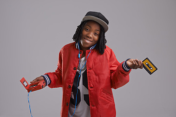 Image showing Music, shrug and child on gray background with cassette for listening to song, audio and radio. Fashion, youth and young African boy with retro tech for track playlist in trendy clothes in studio