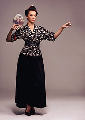 Image showing Fashion, dance and Japanese woman with geisha fan and Asian clothing with traditional outfit in studio. Culture, creative and heritage clothes with female person from Japan with brown background